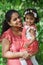 A happy south asian woman with two years old girl