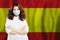 Happy Spanish doctor or nurse in medical safety face mask on Spainish flag background. Flu epidemic and virus protection in Spain