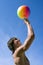 Happy sport build teenager boy with ball in beach