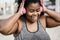 Happy sport curvy black woman listening music with headphones - Focus on face