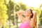 Happy sportswoman breathing fresh air in a park