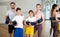 Happy sporty family posing in gym with yoga mats