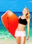 Happy sporty girl playing body board on the beach