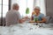 Happy spouses having breakfast in the bed and drinking juice