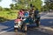 Happy Sri Lankan men Riding a rototiller on a road