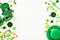 Happy St Patrick`s Day background. Frame borders made of party decorations, leprechauns hats, eyeglasses, gold coins, confetti on