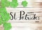 Happy St. Patrick`s Day Black Text Typography Background with Green Shamrocks on Wooden Texture