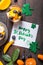 Happy st. Patrick`s day. Card with food and lucky clover. Fresh fruit salad  on wooden table. Shot from aerial view