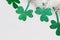 Happy St. Patricks Day background. Green glitter shamrocks homemade garland, copy space