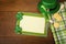 Happy St. Patricks Day Menu or Invite Card with Shamrocks, Hat, Lucky Coins, Napkins and fork from top down view with blank room