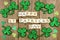 Happy St Patricks Day wooden blocks with shamrocks on rustic wood