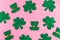Happy St. Patrickâ€™s Day. Green hat and shamrock pattern on pink glitter background.