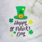 Happy St. Patrickâ€™s day paper cut letters with Leprechaunâ€™s hat and shamrock on background.