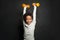 Happy strong black child boy holding dumbbells