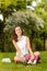 Happy student girl sitting grass open schoolbag