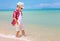 Happy stylish boy walking on summer beach