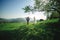 Happy stylish bride and groom running and having fun in mountains on summer sunny day. gorgeous newlywed couple laughing, true