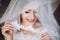 Happy stylish bride smiling and looking under veil. space for text. gorgeous emotional bride getting ready and having fun in the