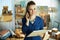 Happy stylish business owner woman talking on phone in office