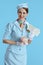 happy stylish female air hostess on blue