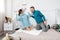 Happy stylish loving couple having a pillow fight in bed. young man and woman expecting baby for Christmas