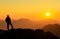 Happy success winning man standing relaxed on mountain at sunset. Border region of Tyrol, Austria and Allgaeu, Bavaria