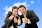 Happy successful business Hispanic woman and Caucasian man wearing suits giving thumbs up smiling on blue sky