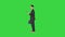 Happy Successful Businessman Dancing Listening Music From the Phone And Walking on a Green Screen, Chroma Key.