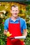 Happy successful businessman gardener in a greenhouse