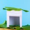 Happy Sukkot. A hut made of paper covered with leaves on a blue background. Copy the space.