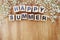 Happy summer alphabet letters on wooden background