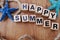 Happy summer with nautical decoration on wooden background