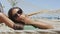 Happy sunglasses girl tanning relaxing in beach hammock saying hi waving hello