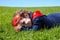 Happy Superhero toddler lay on green grass