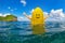 Happy surfer girl sit on yellow surfboard with smiley face