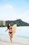 Happy surfer girl surfing on Waikiki Beach, Hawaii