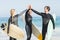 Happy surfer giving high-five to each other on the beach