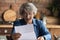 Happy surprised older woman reading paper letter with unexpected news.