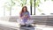 Happy surprised redhead young woman getting good news on cell phone while sitting on bench.