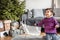 Happy surprised toddler girl to see a lot holiday gifts under Christmas tree. Merry Christmas and Happy New Year! Cute little