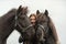 Happy Swedish girl hugging and holding her two dark Icelandic horses