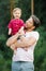 Happy and sweet moments of a summer walk in the park of a father and a little son