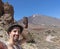 Happy tan Handsome guy with beard holding black hat and joyful, taking a selfie at Teide National Park in Tenerife