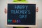 Happy teacher`s day. Boy hold chalkboard with blue inscription