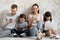 Happy technology addicted parents and kids use devices at home
