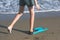Happy teen boy in the swim flippers having fun on the sand Ð¾n the beach