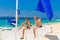 Happy teen boys on the sailboat on the tropical beach. Summer va