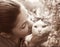 Happy teen girl with cat close up sepia black and white portrait on summer garden background
