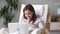 Happy teen girl enjoy using laptop sitting in rocking chair