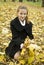 Happy teen girl grabs a bunch of yellow leaves